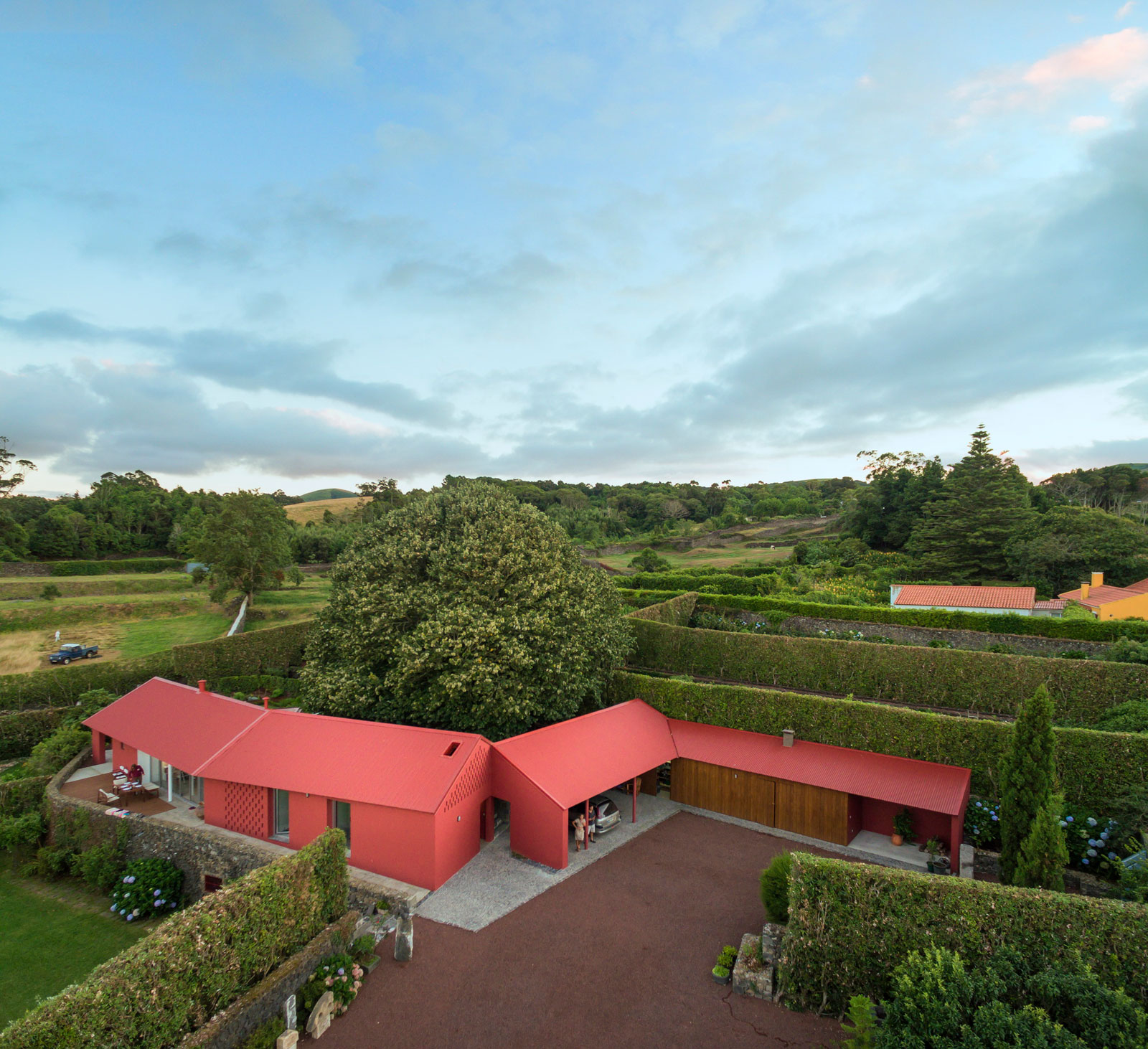 A Bright Contemporary Red Home Consists of Two Volumes Connected by a Wide Corridor in Ponta Delgada by Pedro Mauricio Borges (1)
