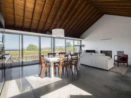 A Bright Contemporary Red Home Consists of Two Volumes Connected by a Wide Corridor in Ponta Delgada by Pedro Mauricio Borges (14)