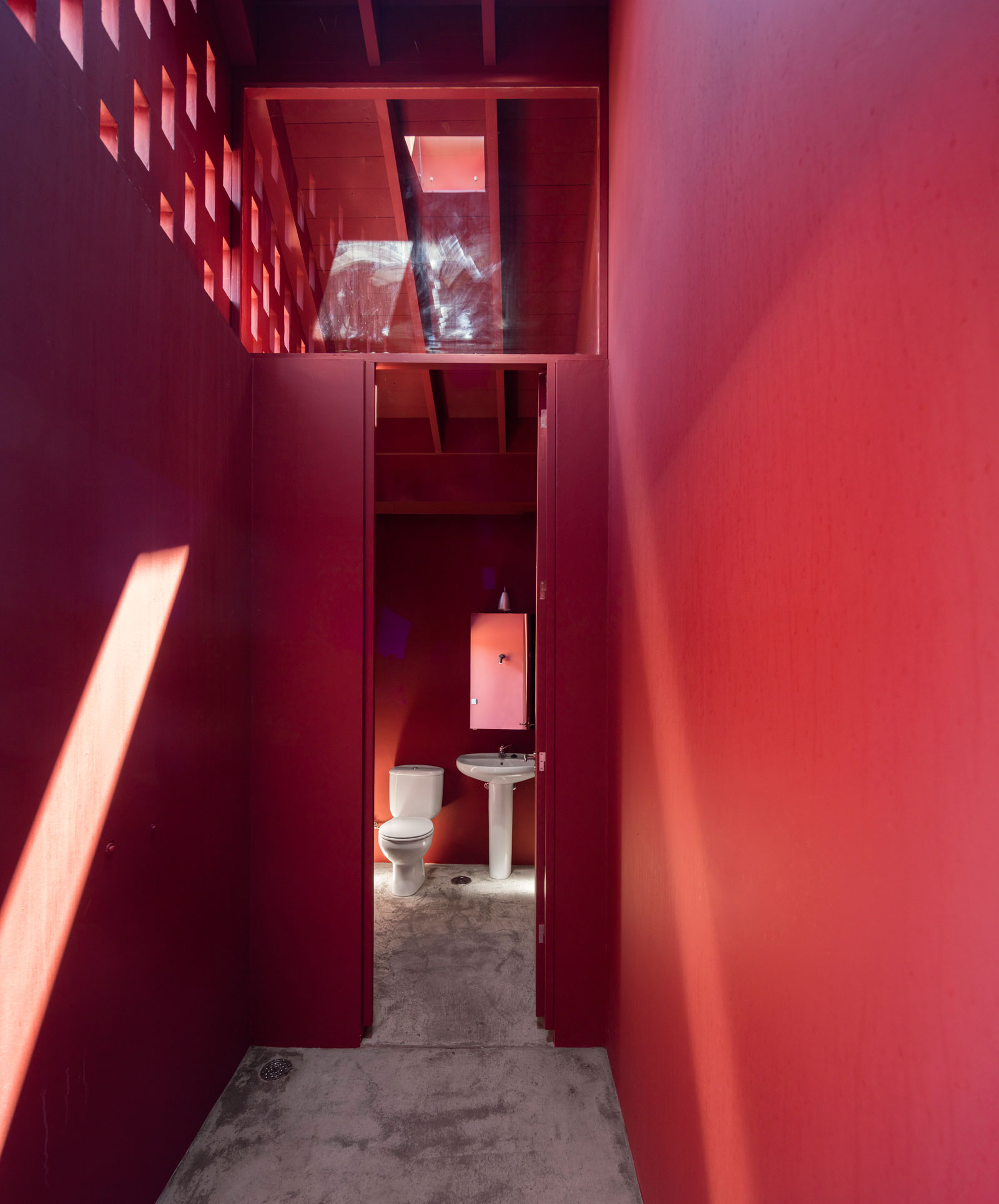 A Bright Contemporary Red Home Consists of Two Volumes Connected by a Wide Corridor in Ponta Delgada by Pedro Mauricio Borges (18)