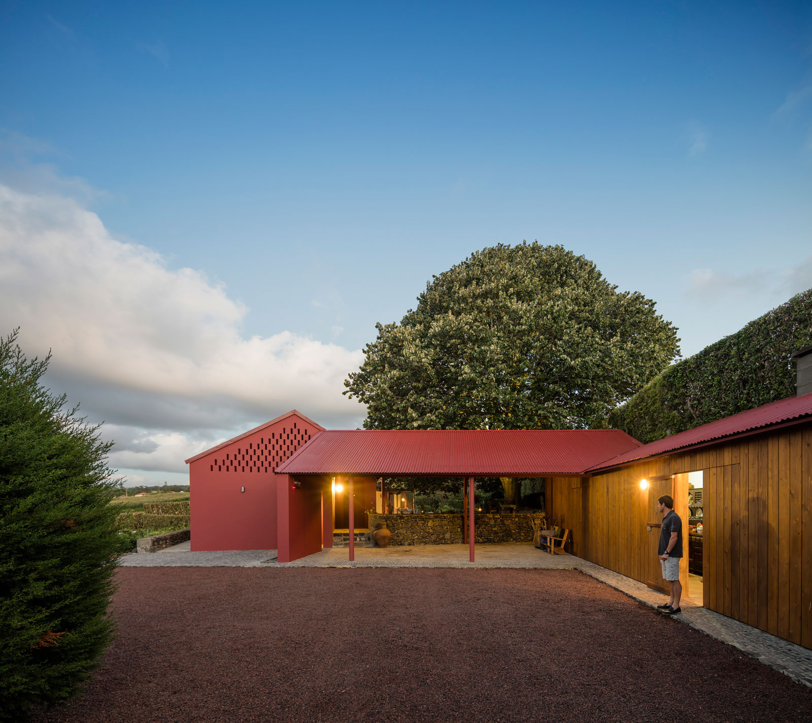 A Bright Contemporary Red Home Consists of Two Volumes Connected by a Wide Corridor in Ponta Delgada by Pedro Mauricio Borges (20)