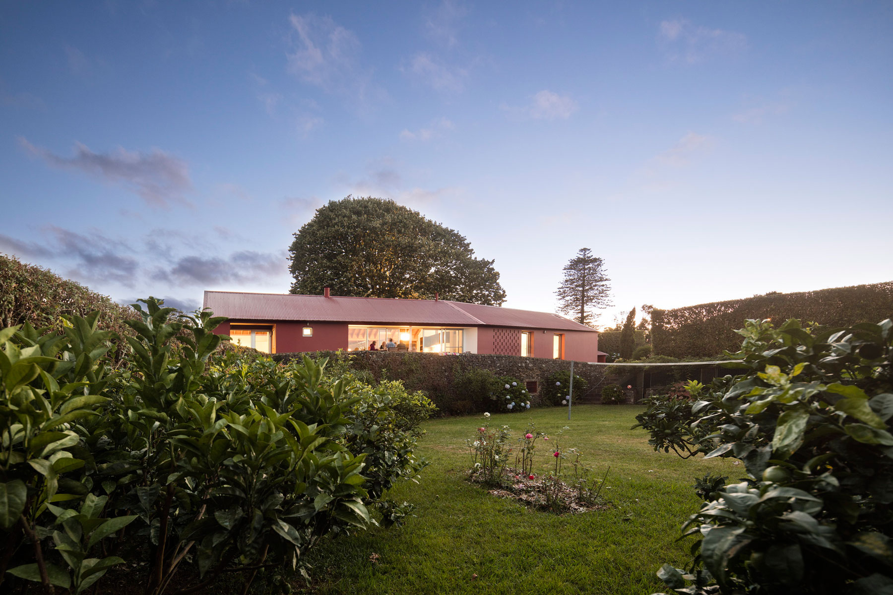 A Bright Contemporary Red Home Consists of Two Volumes Connected by a Wide Corridor in Ponta Delgada by Pedro Mauricio Borges (22)