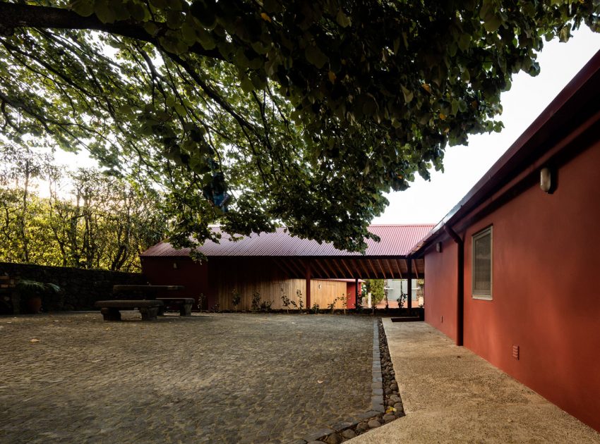 A Bright Contemporary Red Home Consists of Two Volumes Connected by a Wide Corridor in Ponta Delgada by Pedro Mauricio Borges (3)