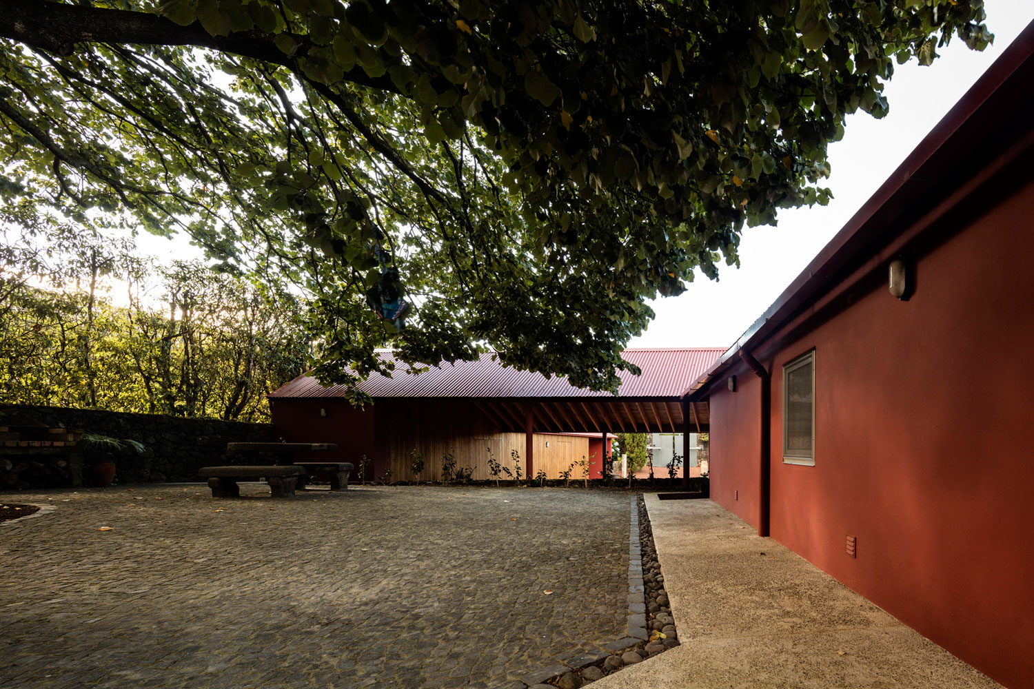 A Bright Contemporary Red Home Consists of Two Volumes Connected by a Wide Corridor in Ponta Delgada by Pedro Mauricio Borges (3)