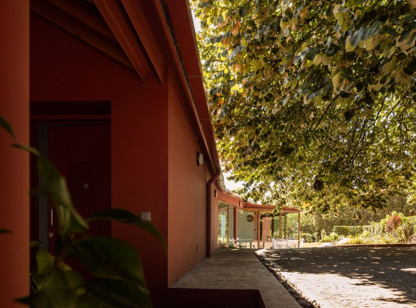 A Bright Contemporary Red Home Consists of Two Volumes Connected by a Wide Corridor in Ponta Delgada by Pedro Mauricio Borges (4)