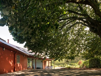 A Bright Contemporary Red Home Consists of Two Volumes Connected by a Wide Corridor in Ponta Delgada by Pedro Mauricio Borges (5)