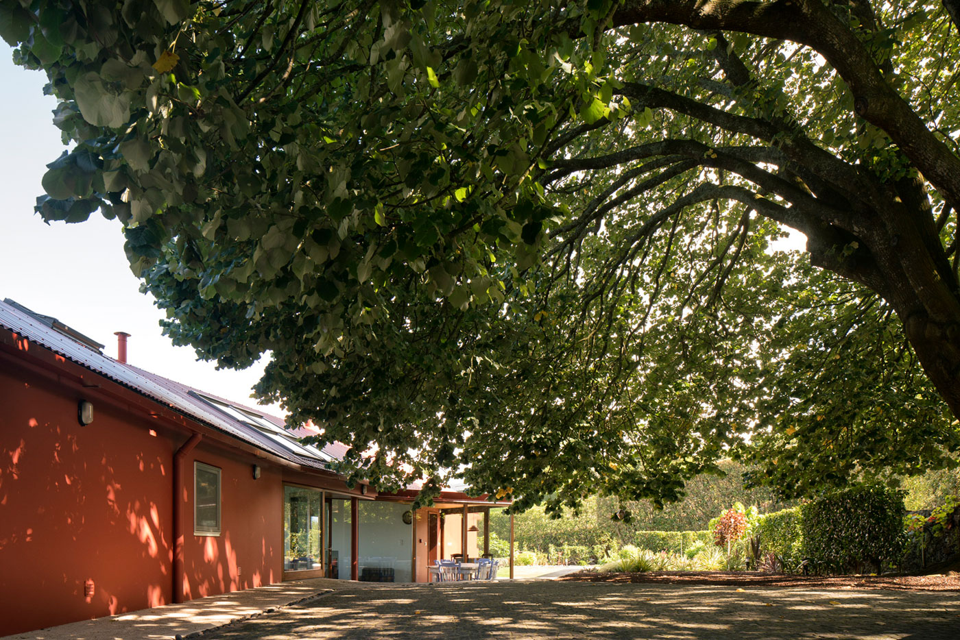 A Bright Contemporary Red Home Consists of Two Volumes Connected by a Wide Corridor in Ponta Delgada by Pedro Mauricio Borges (5)