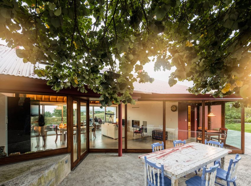 A Bright Contemporary Red Home Consists of Two Volumes Connected by a Wide Corridor in Ponta Delgada by Pedro Mauricio Borges (6)