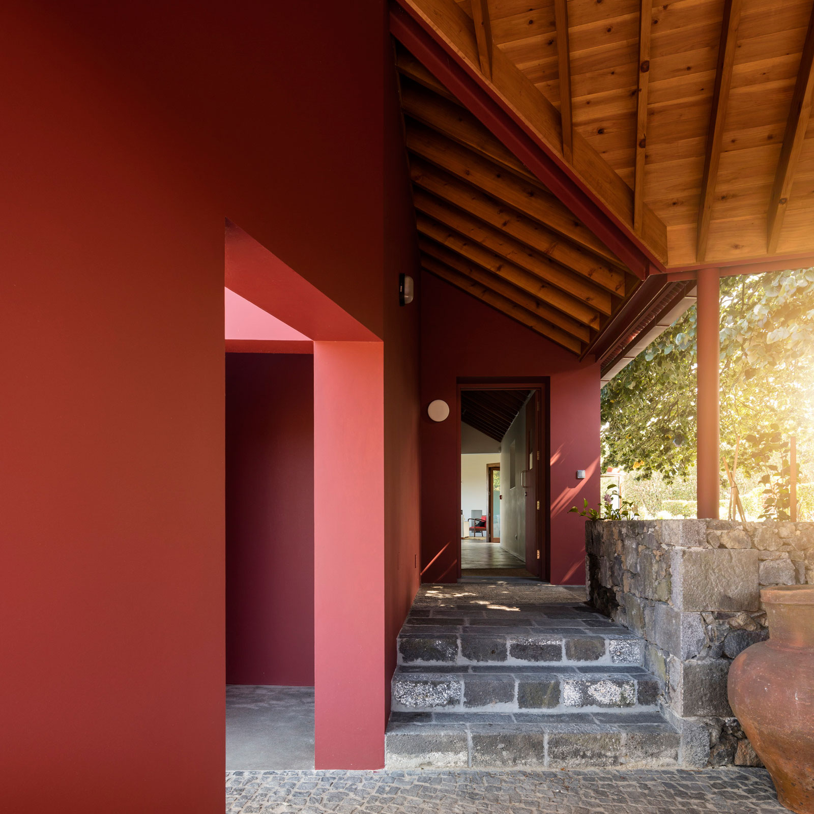 A Bright Contemporary Red Home Consists of Two Volumes Connected by a Wide Corridor in Ponta Delgada by Pedro Mauricio Borges (8)