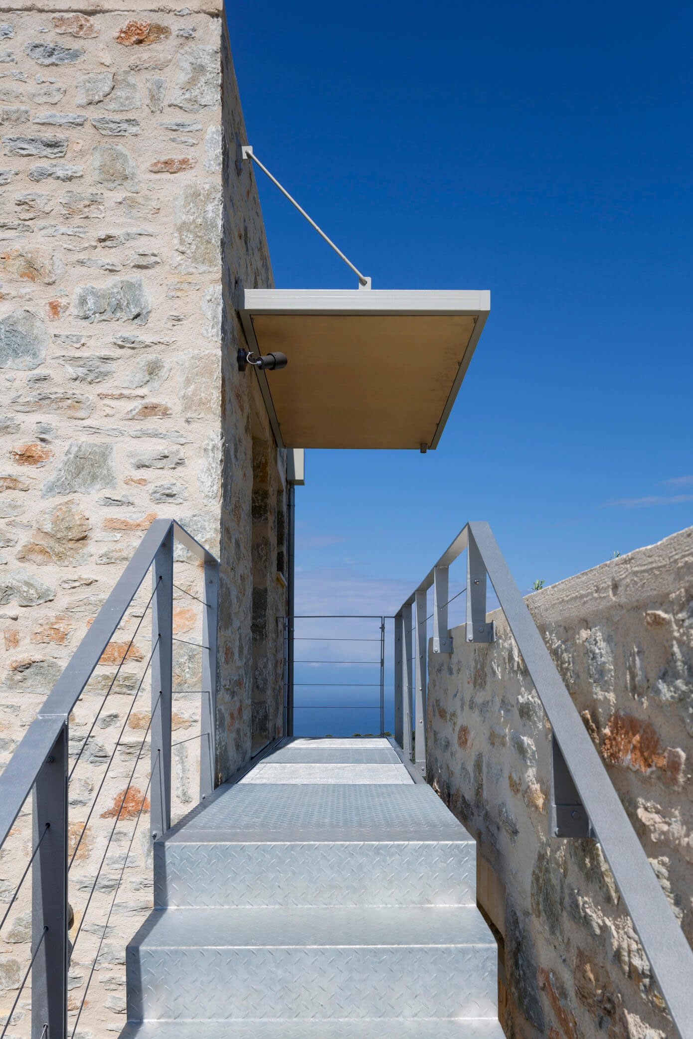 A Spacious Light-Filled Home with Stone Walls and Unique Style on Skiathos, Greece by HHH Architects (12)