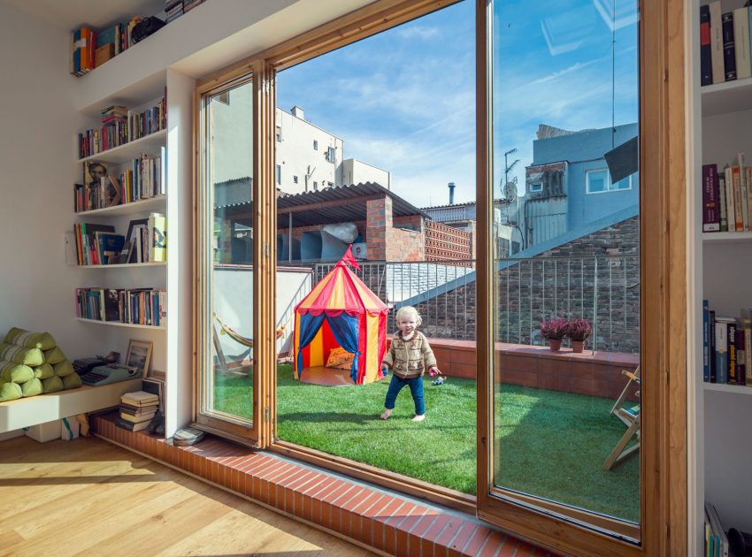 A Colorful and Playful Row Home Separated by Stairs and Mesh Partitions in Barcelona, Spain by Nook Architects (10)