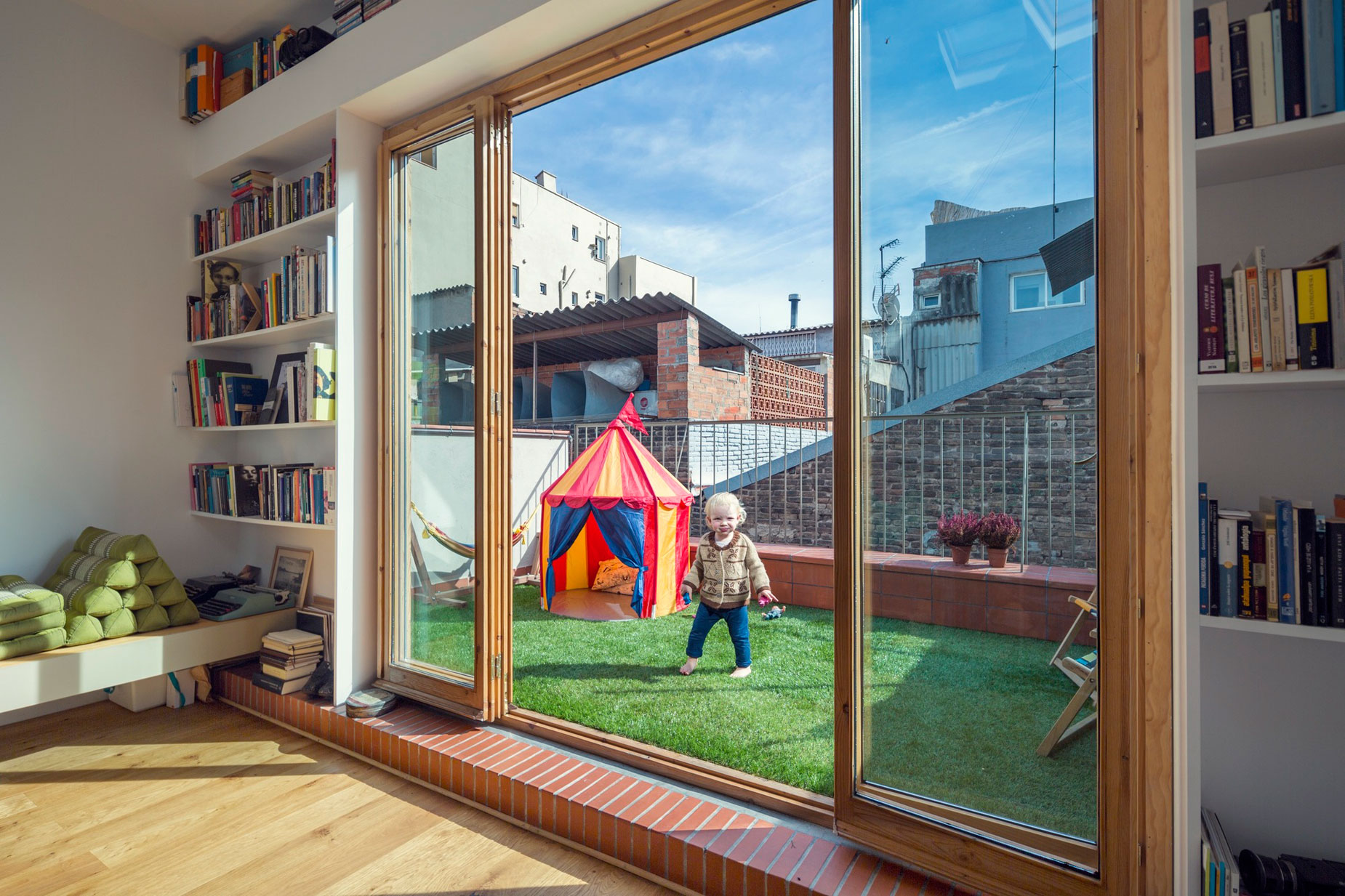 A Colorful and Playful Row Home Separated by Stairs and Mesh Partitions in Barcelona, Spain by Nook Architects (10)