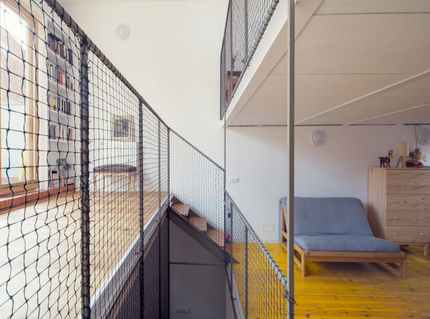 A Colorful and Playful Row Home Separated by Stairs and Mesh Partitions in Barcelona, Spain by Nook Architects (12)