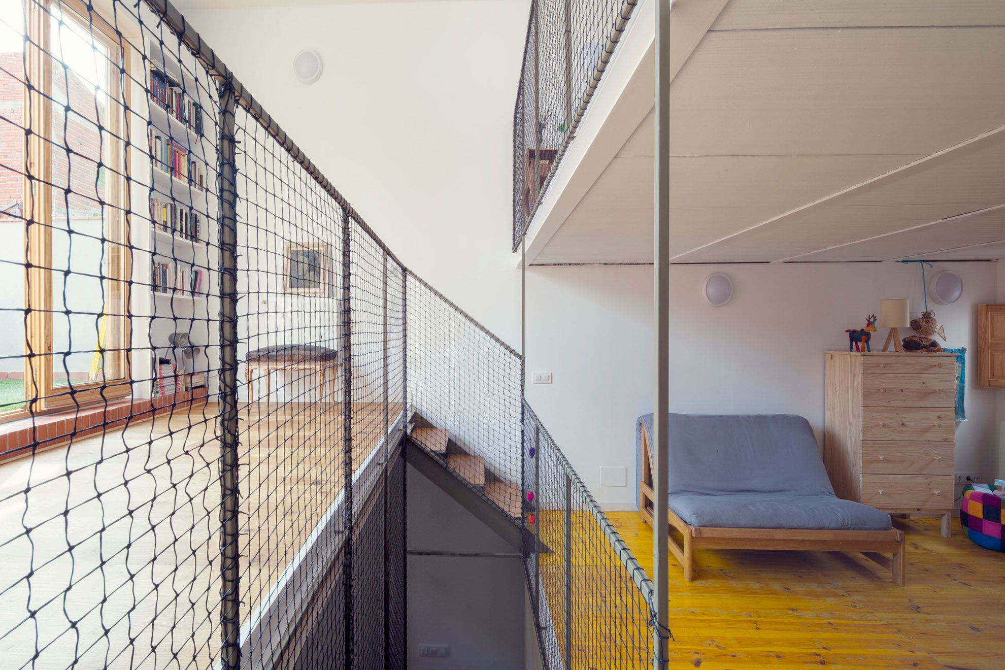 A Colorful and Playful Row Home Separated by Stairs and Mesh Partitions in Barcelona, Spain by Nook Architects (12)