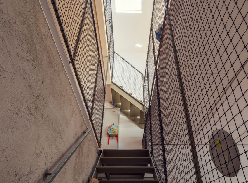 A Colorful and Playful Row Home Separated by Stairs and Mesh Partitions in Barcelona, Spain by Nook Architects (5)