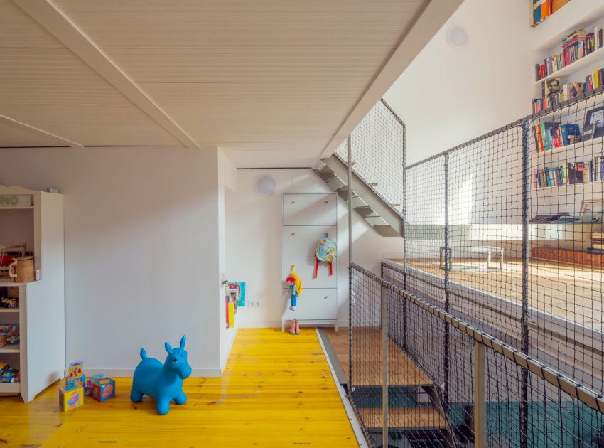 A Colorful and Playful Row Home Separated by Stairs and Mesh Partitions in Barcelona, Spain by Nook Architects (6)