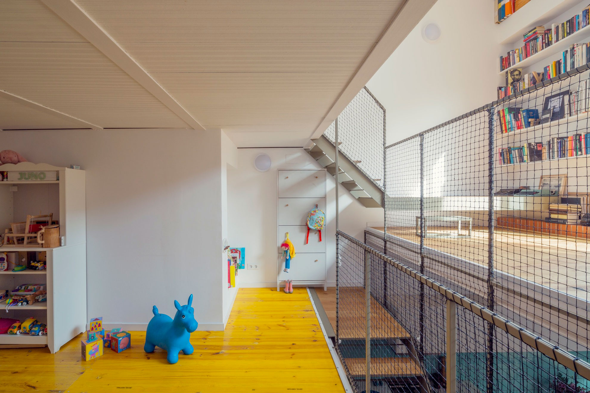 A Colorful and Playful Row Home Separated by Stairs and Mesh Partitions in Barcelona, Spain by Nook Architects (6)