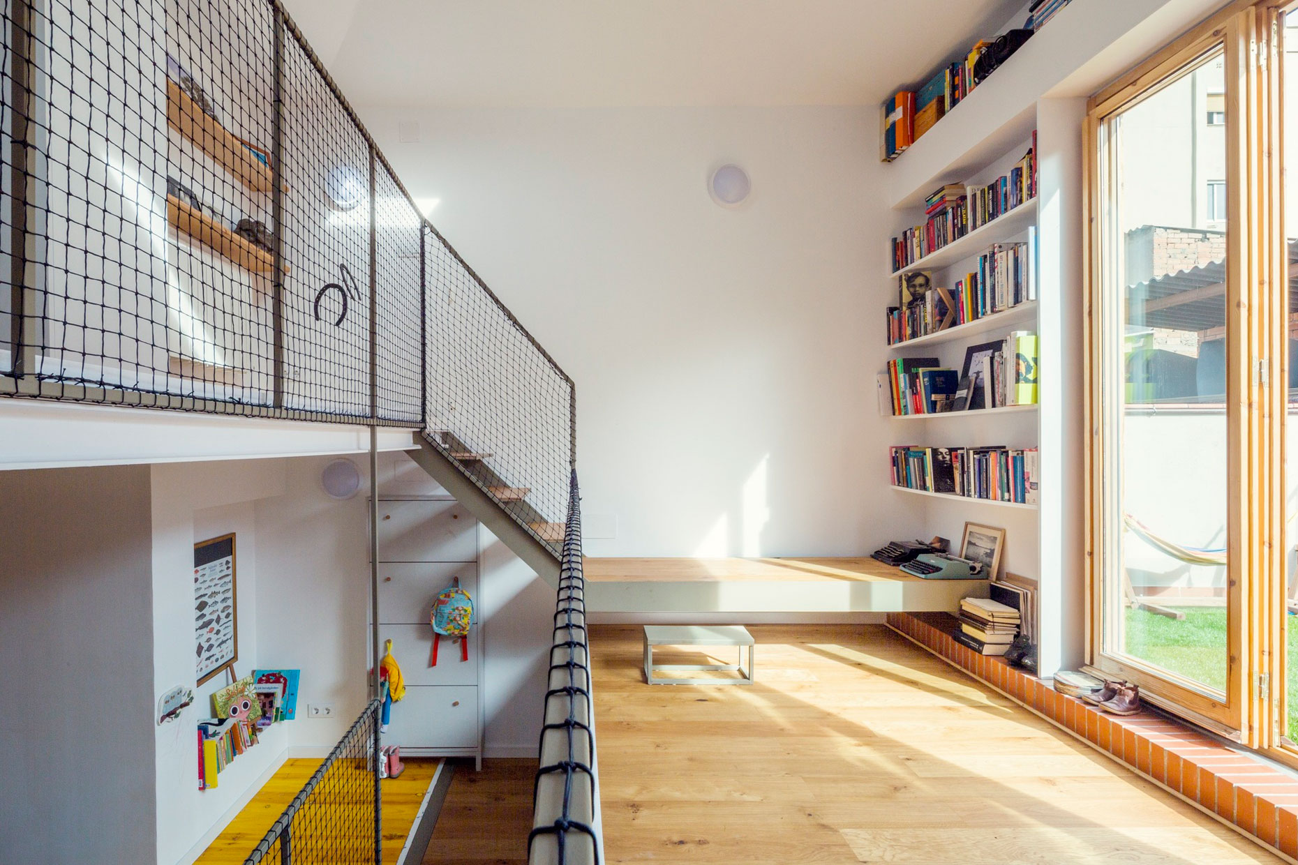 A Colorful and Playful Row Home Separated by Stairs and Mesh Partitions in Barcelona, Spain by Nook Architects (7)