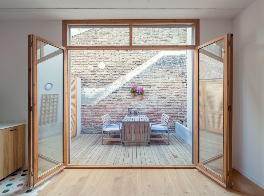 A Colorful and Playful Row Home Separated by Stairs and Mesh Partitions in Barcelona, Spain by Nook Architects (8)