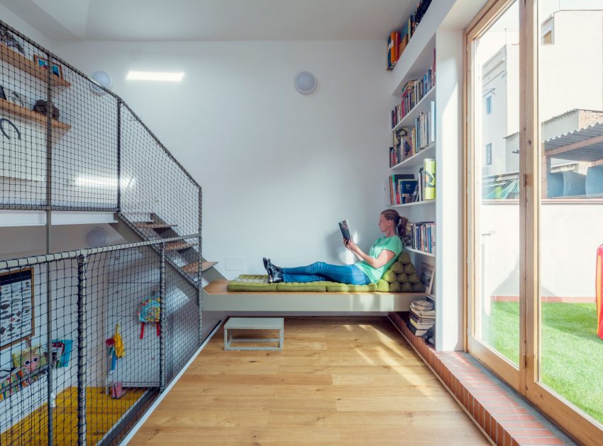 A Colorful and Playful Row Home Separated by Stairs and Mesh Partitions in Barcelona, Spain by Nook Architects (9)