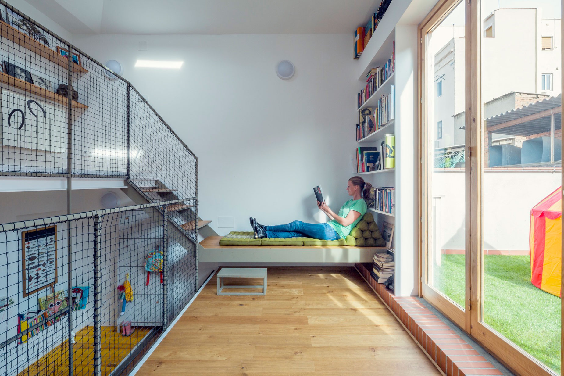 A Colorful and Playful Row Home Separated by Stairs and Mesh Partitions in Barcelona, Spain by Nook Architects (9)