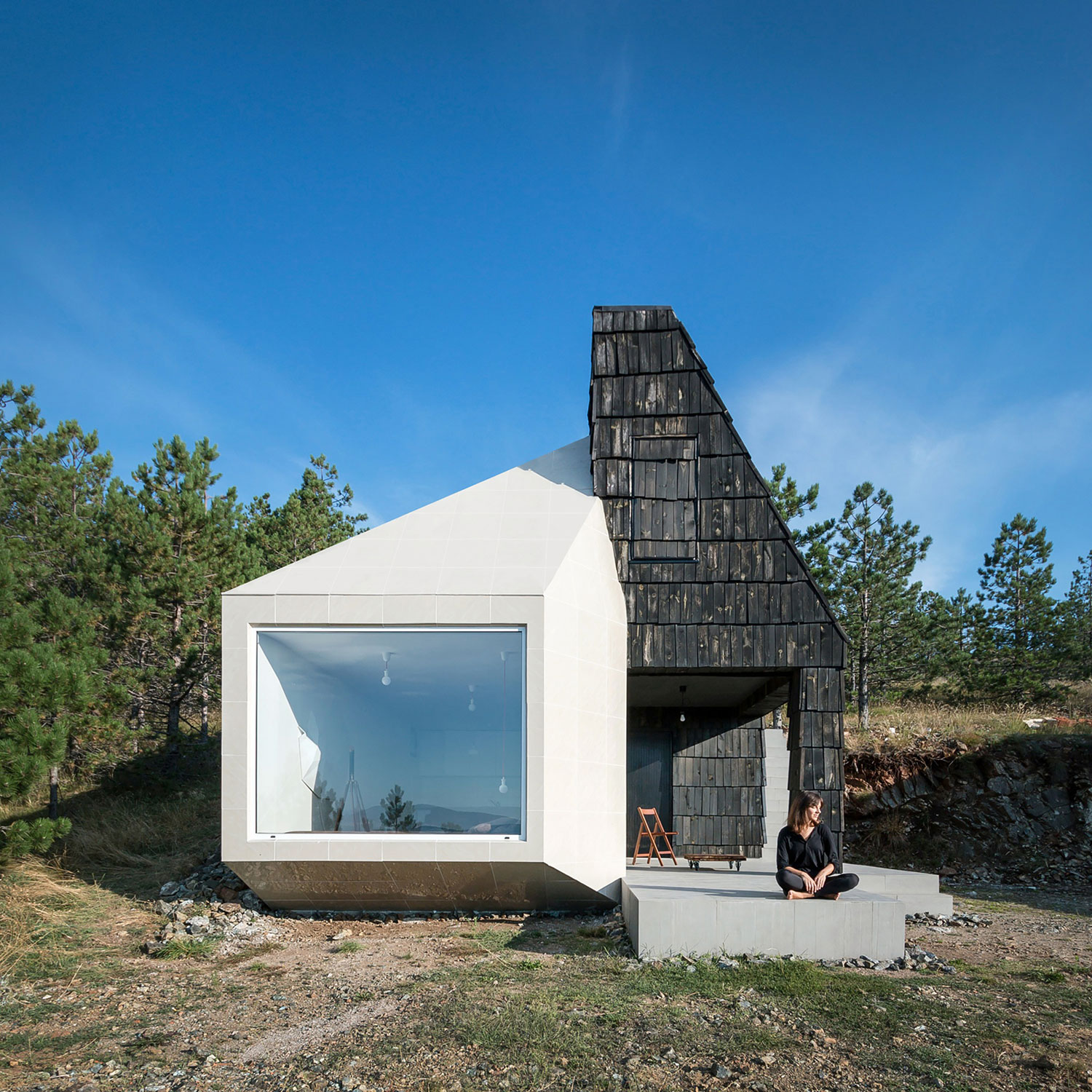 A Contemporary Mountain Home Enclosed by White Ceramic Tiles and Dark Wooden Shingles in Divčibare by EXE studio (1)