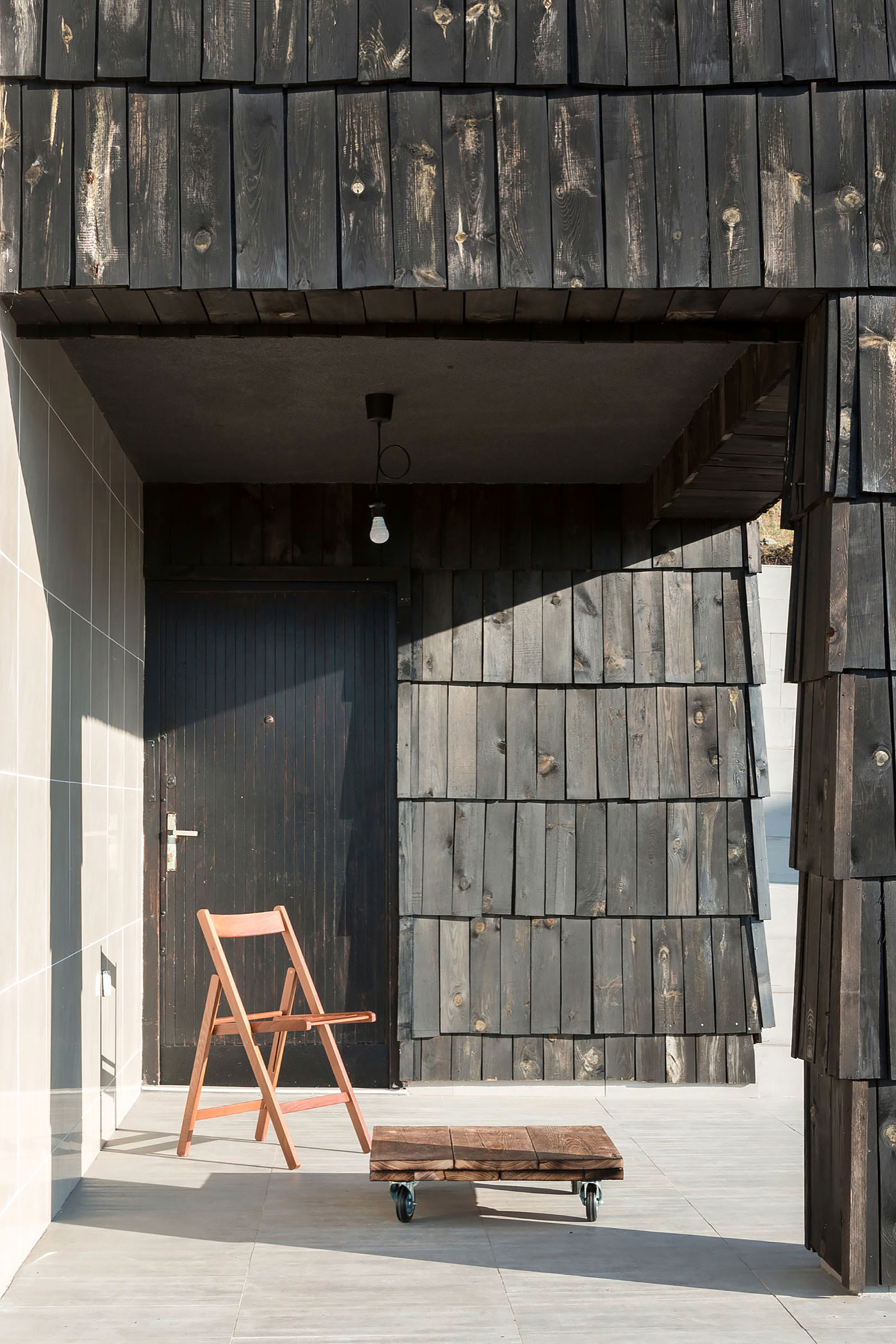 A Contemporary Mountain Home Enclosed by White Ceramic Tiles and Dark Wooden Shingles in Divčibare by EXE studio (6)