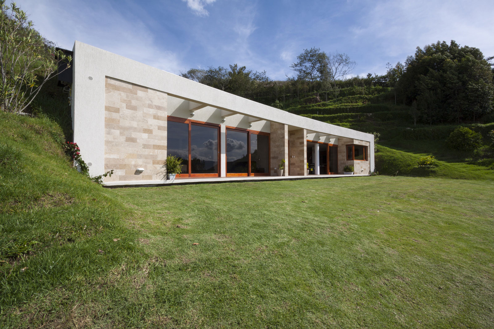 A Modern Concrete House Surrounded by a Green Roof and Basement Level in Guayllabamba, Ecuador by AR+C (1)