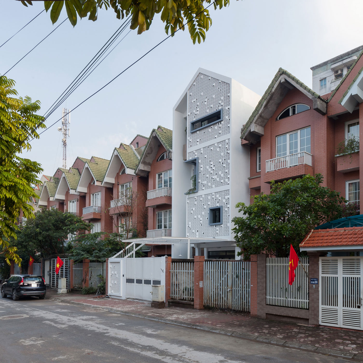 A Row House Transformed into a Bright Home with White Concrete Blocks in Vietnam by LANDMAK ARCHITECTURE (1)