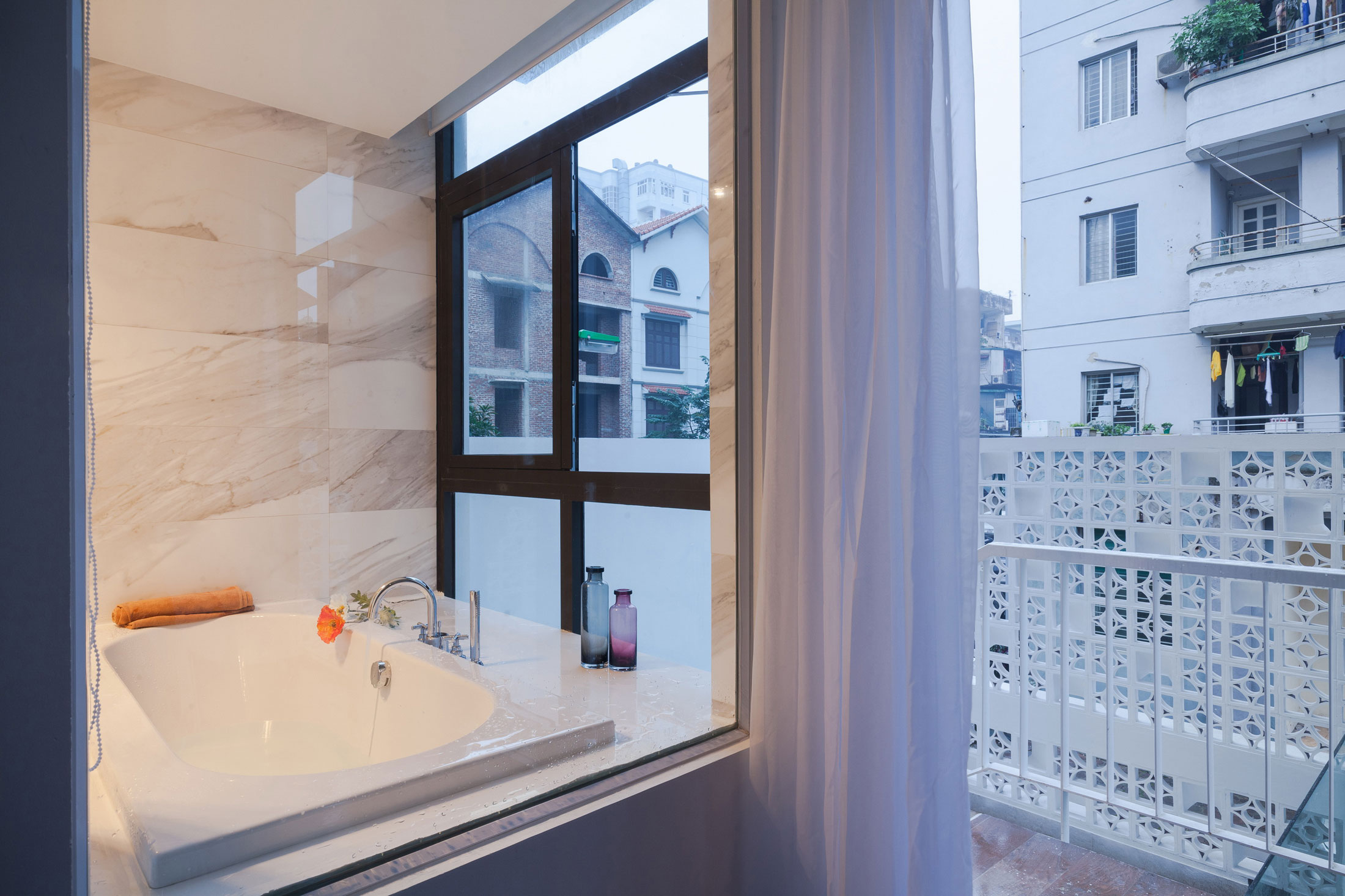 A Row House Transformed into a Bright Home with White Concrete Blocks in Vietnam by LANDMAK ARCHITECTURE (20)