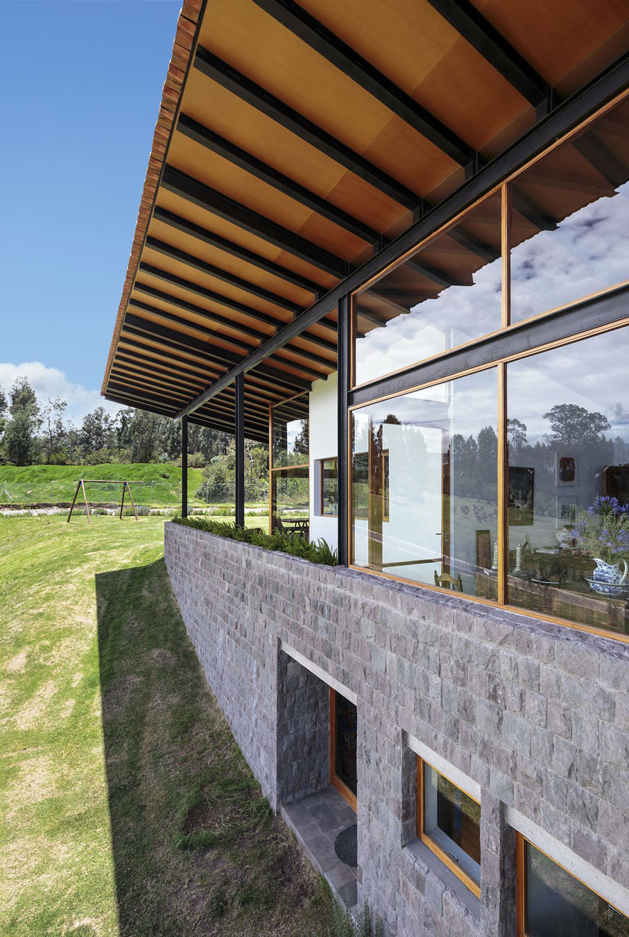 A Rustic Contemporary Home with Facade Composed of Stone and Glass Elements in Ecuador by Diez + Muller Arquitectos (4)