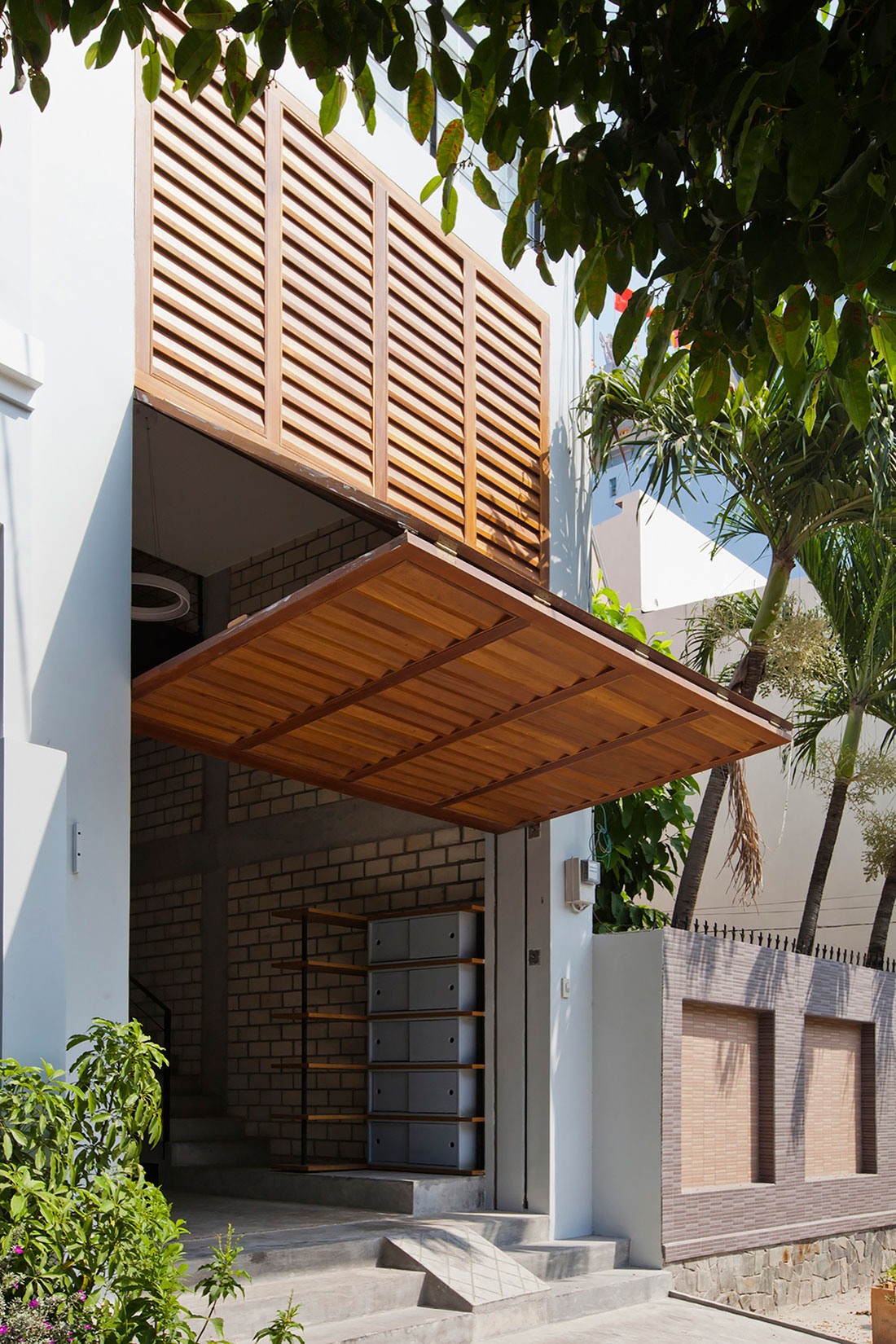 An Elegant and Light-Filled Modern Townhouse with a Folding-Up Shutter in Ho Chi Minh by MM++ architects (3)