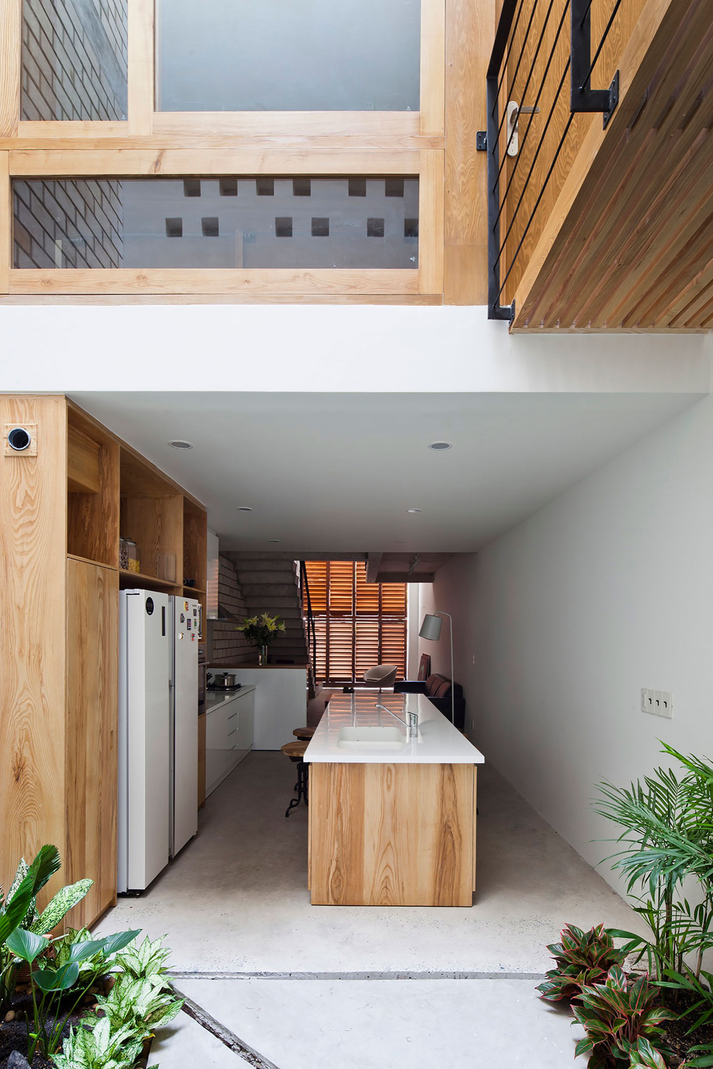 An Elegant and Light-Filled Modern Townhouse with a Folding-Up Shutter in Ho Chi Minh by MM++ architects (9)