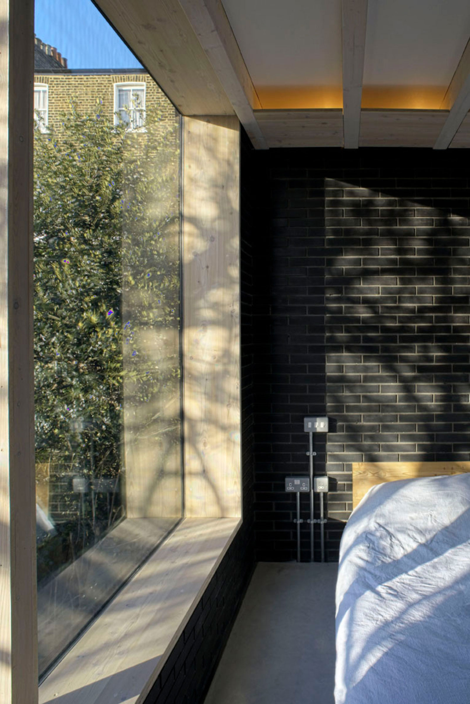 A Fascinating Home with Black Engineering Bricks and Slabs of White Marble in London by Liddicoat & Goldhill (13)