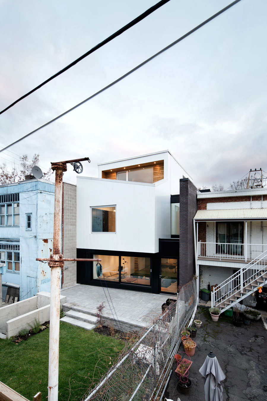 A Home with a Brick Front and a Monochrome Back for Family of Four in Montreal by NatureHumaine (2)