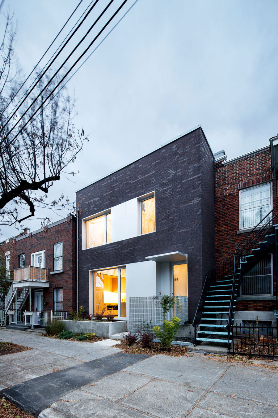A Home with a Brick Front and a Monochrome Back for Family of Four in Montreal by NatureHumaine (4)