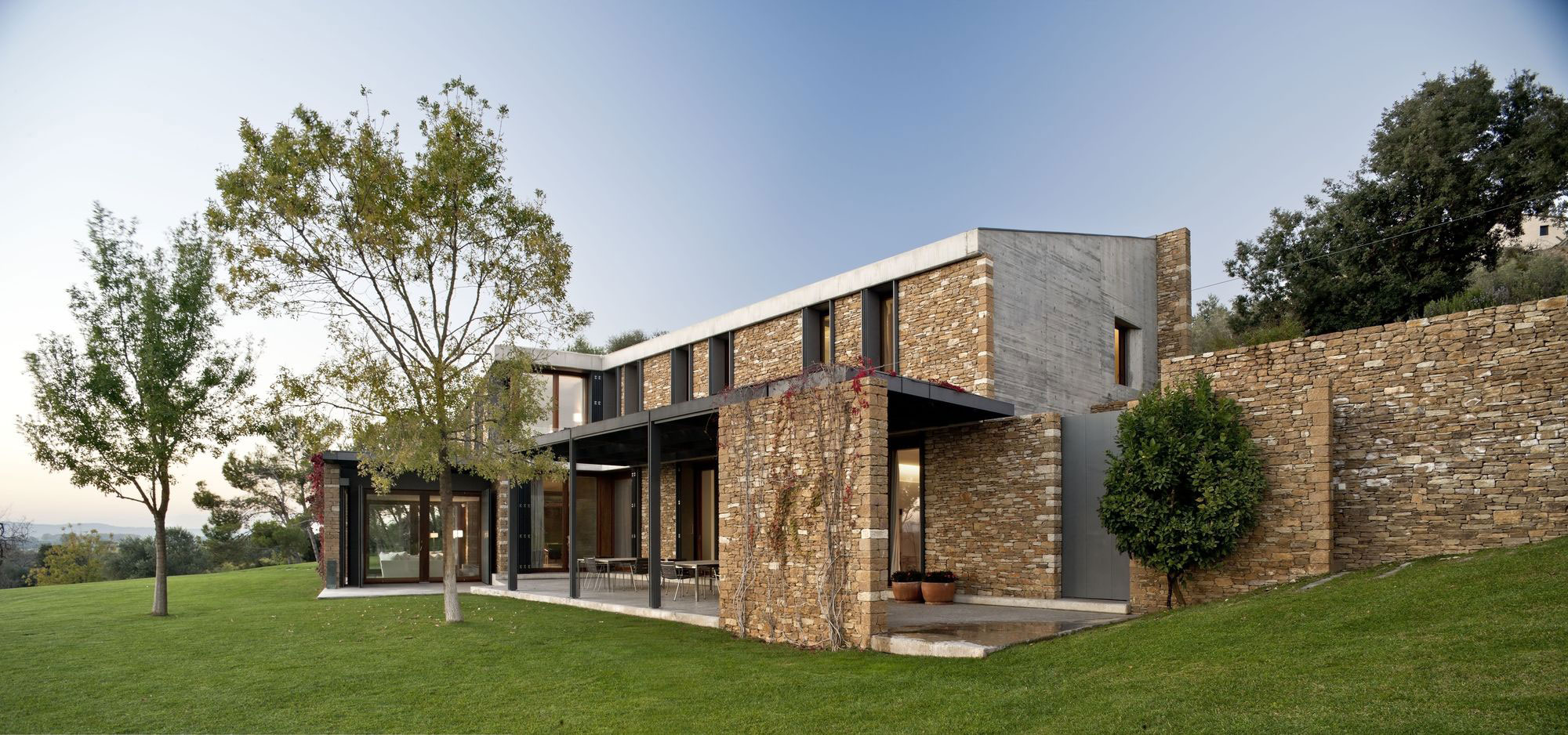 A Modern House with Stone on the Outside and Exposed Concrete on the Inside in El Ampurdán by b720 Fermín Vázquez Arquitectos (13)