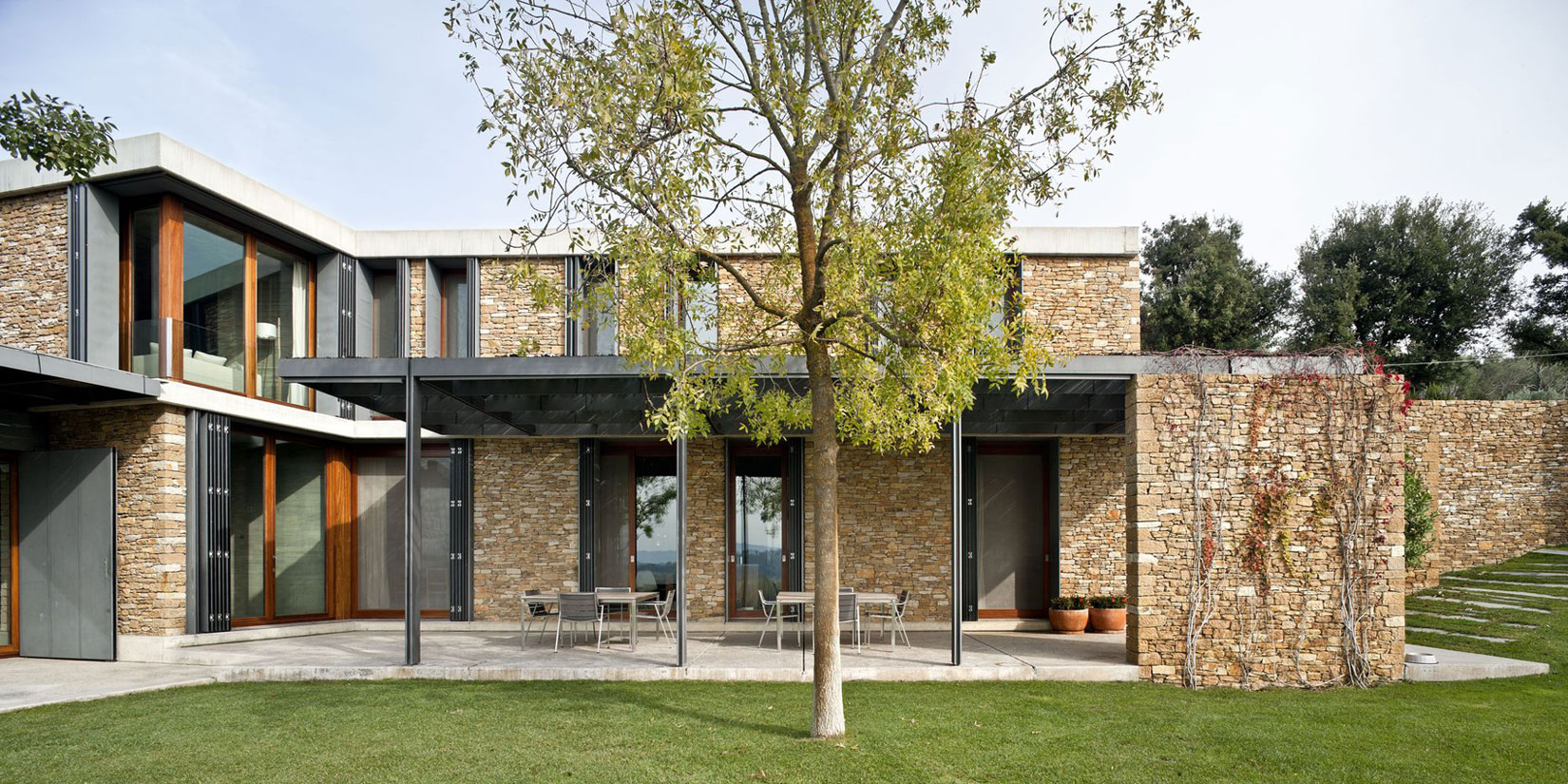 A Modern House with Stone on the Outside and Exposed Concrete on the Inside in El Ampurdán by b720 Fermín Vázquez Arquitectos (14)