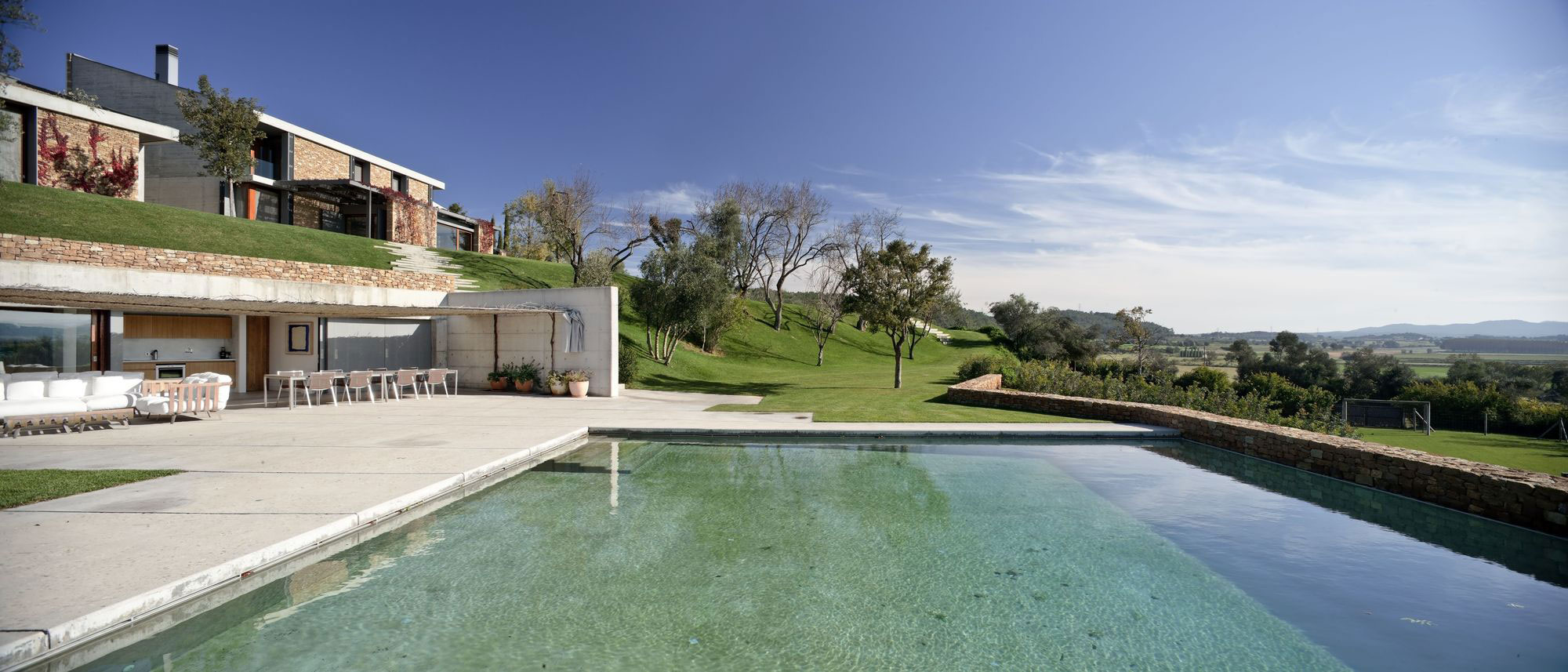 A Modern House with Stone on the Outside and Exposed Concrete on the Inside in El Ampurdán by b720 Fermín Vázquez Arquitectos (15)