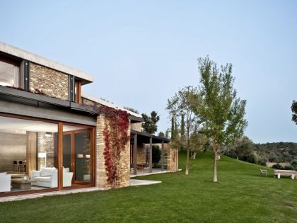 A Modern House with Stone on the Outside and Exposed Concrete on the Inside in El Ampurdán by b720 Fermín Vázquez Arquitectos (2)