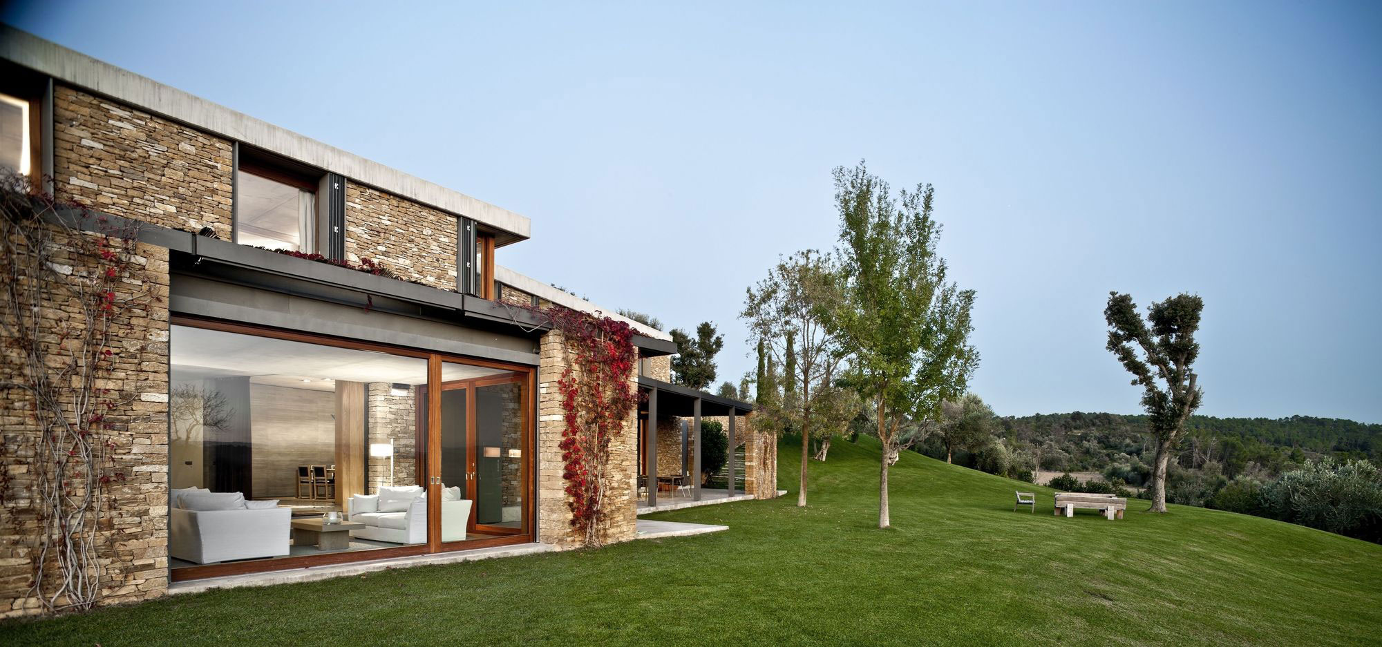 A Modern House with Stone on the Outside and Exposed Concrete on the Inside in El Ampurdán by b720 Fermín Vázquez Arquitectos (2)