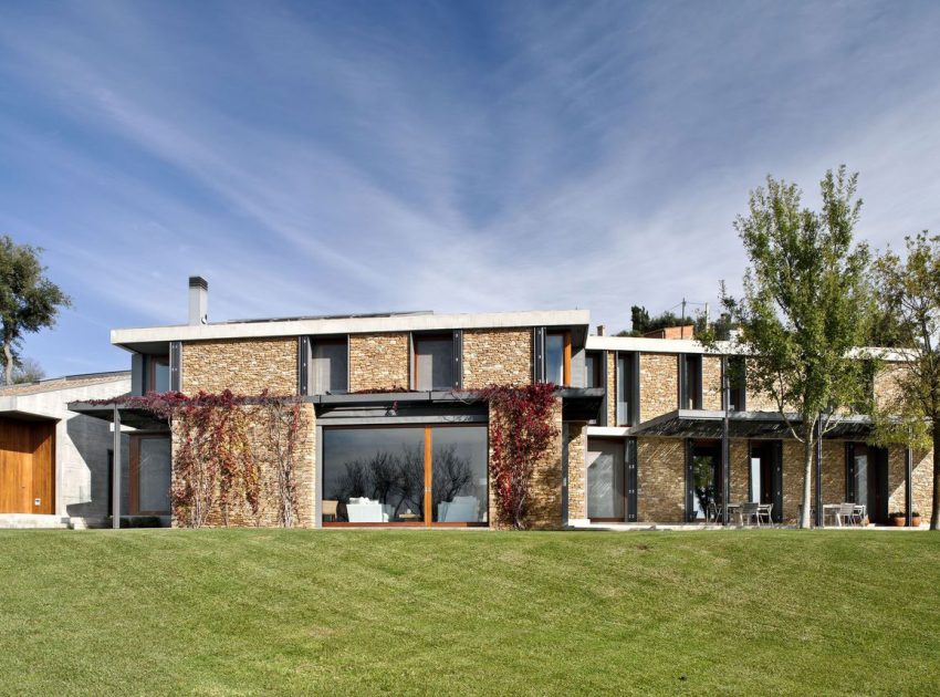 A Modern House with Stone on the Outside and Exposed Concrete on the Inside in El Ampurdán by b720 Fermín Vázquez Arquitectos (5)