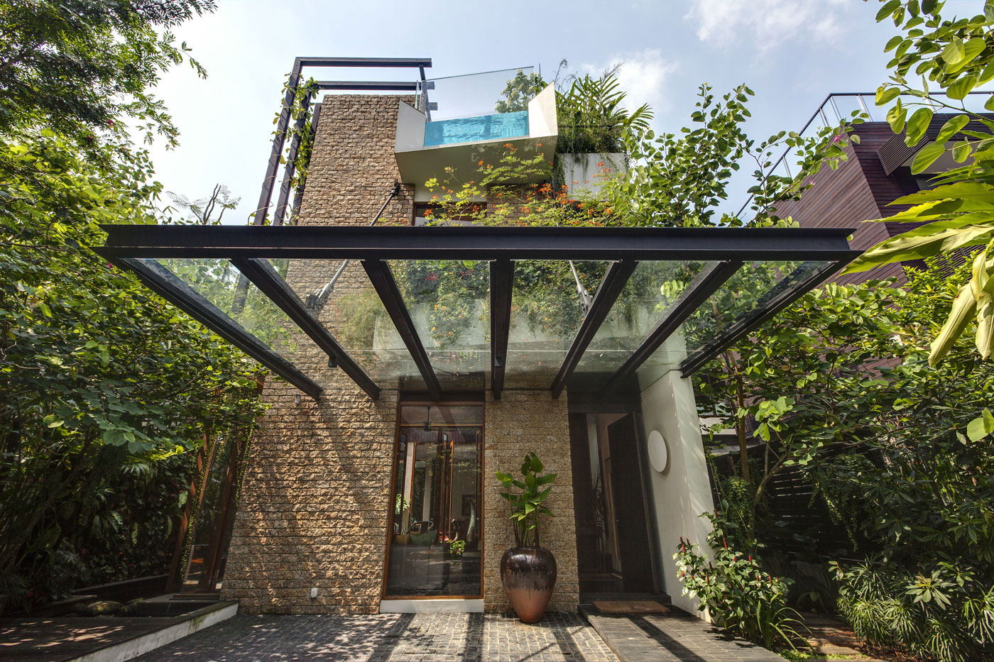A Stunning House Surrounded by Lush Greenery and Courtyard Gardens in Singapore by Aamer Architects (11)