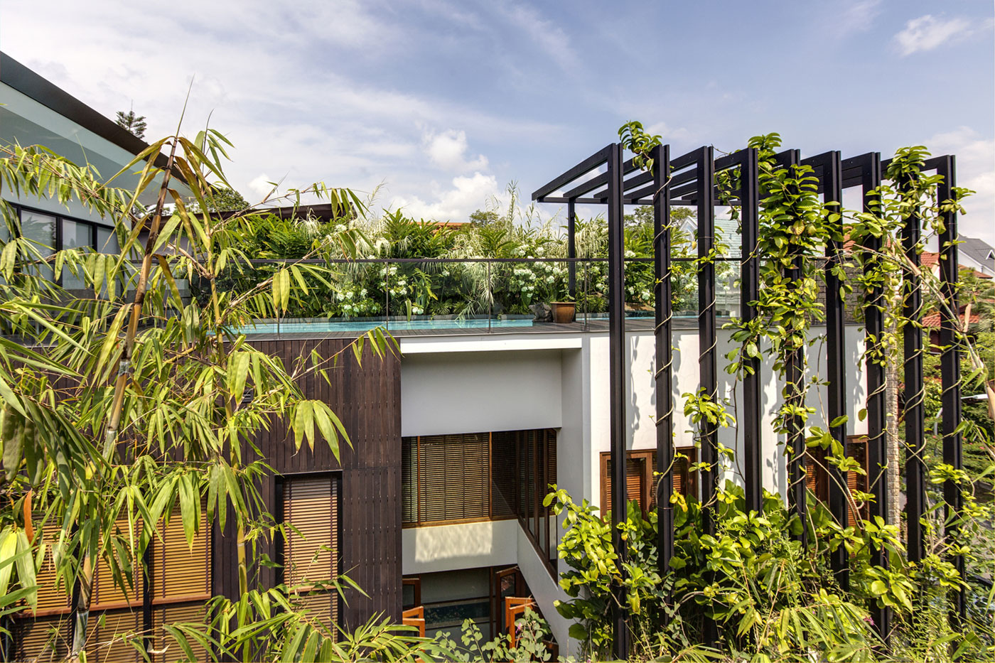 A Stunning House Surrounded by Lush Greenery and Courtyard Gardens in Singapore by Aamer Architects (2)