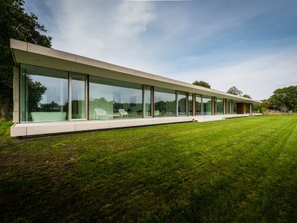 An Elegant and Captivating Modern Transparent House Behind a Grove of Trees in Bontebok, The Netherlands by Inbo (1)