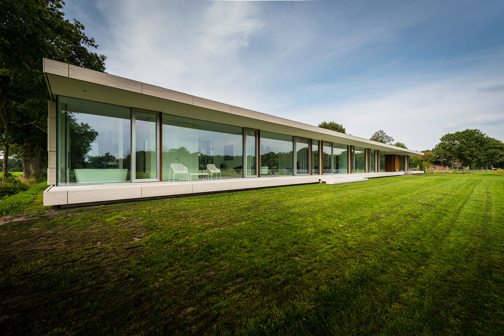 An Elegant and Captivating Modern Transparent House Behind a Grove of Trees in Bontebok, The Netherlands by Inbo (1)