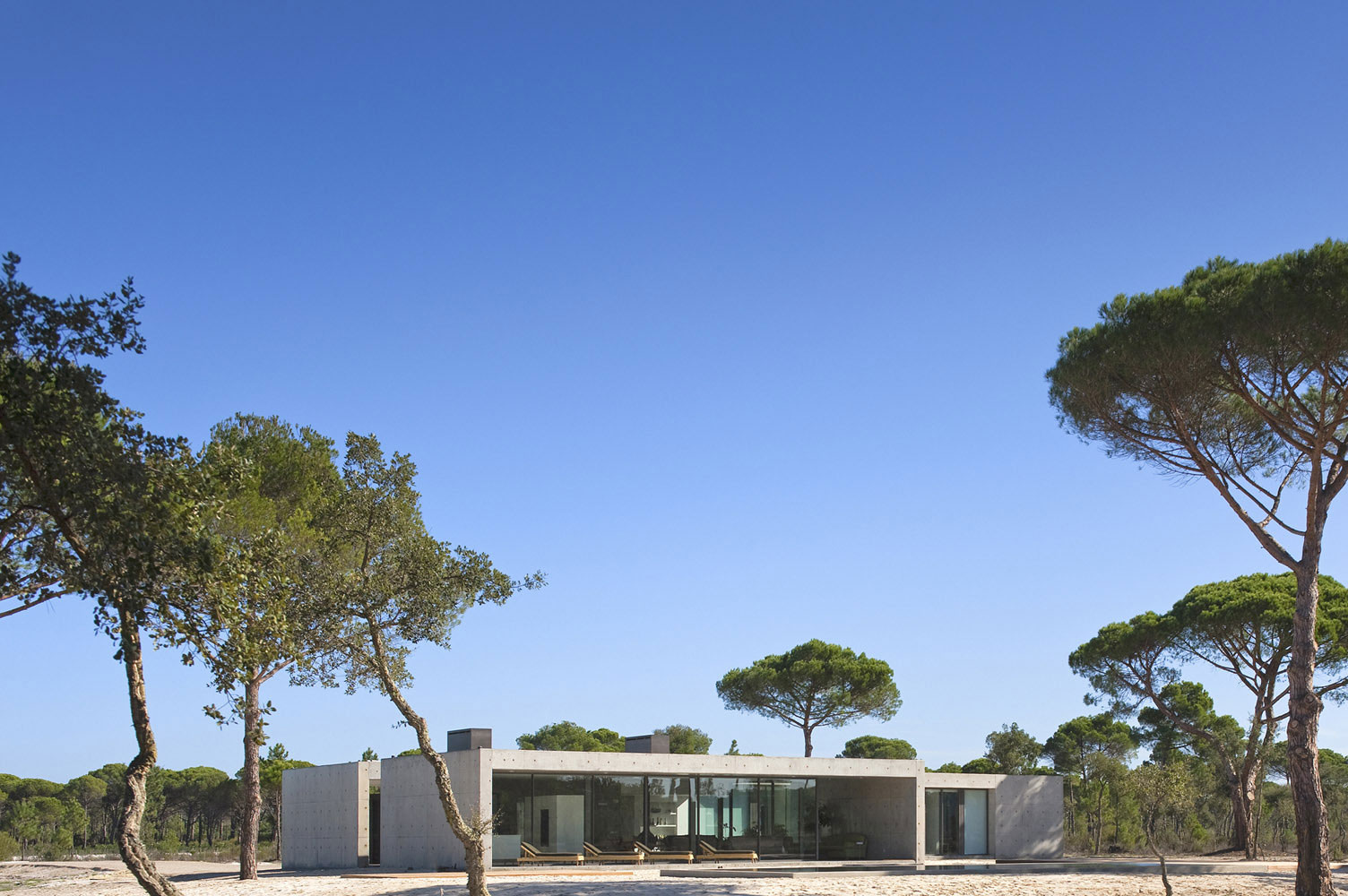 An Elegant Concrete and Glass Home with Warm and Cozy Interior in Comporta, Portugal by RRJ Arquitectos (2)