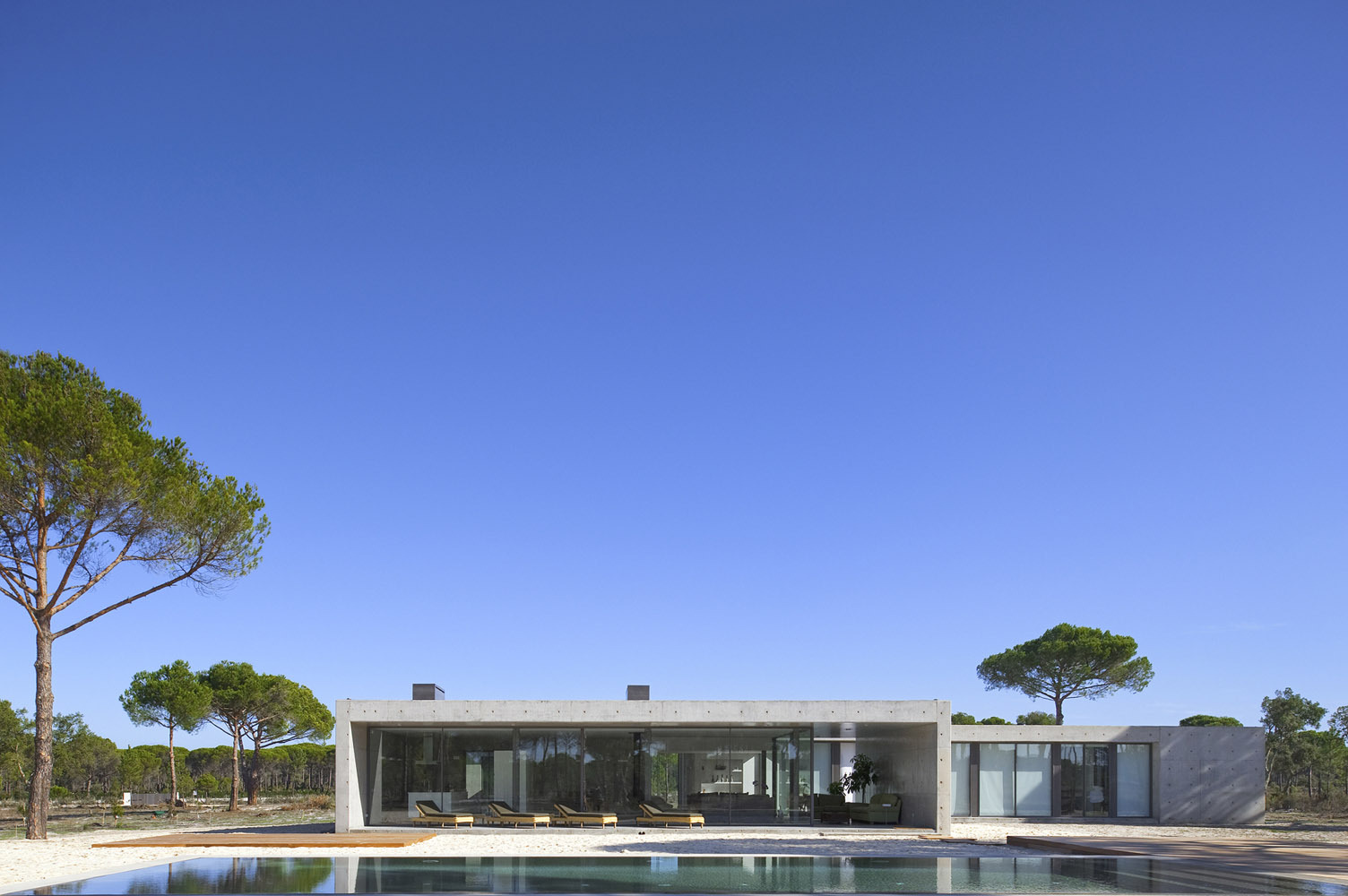 An Elegant Concrete and Glass Home with Warm and Cozy Interior in Comporta, Portugal by RRJ Arquitectos (4)