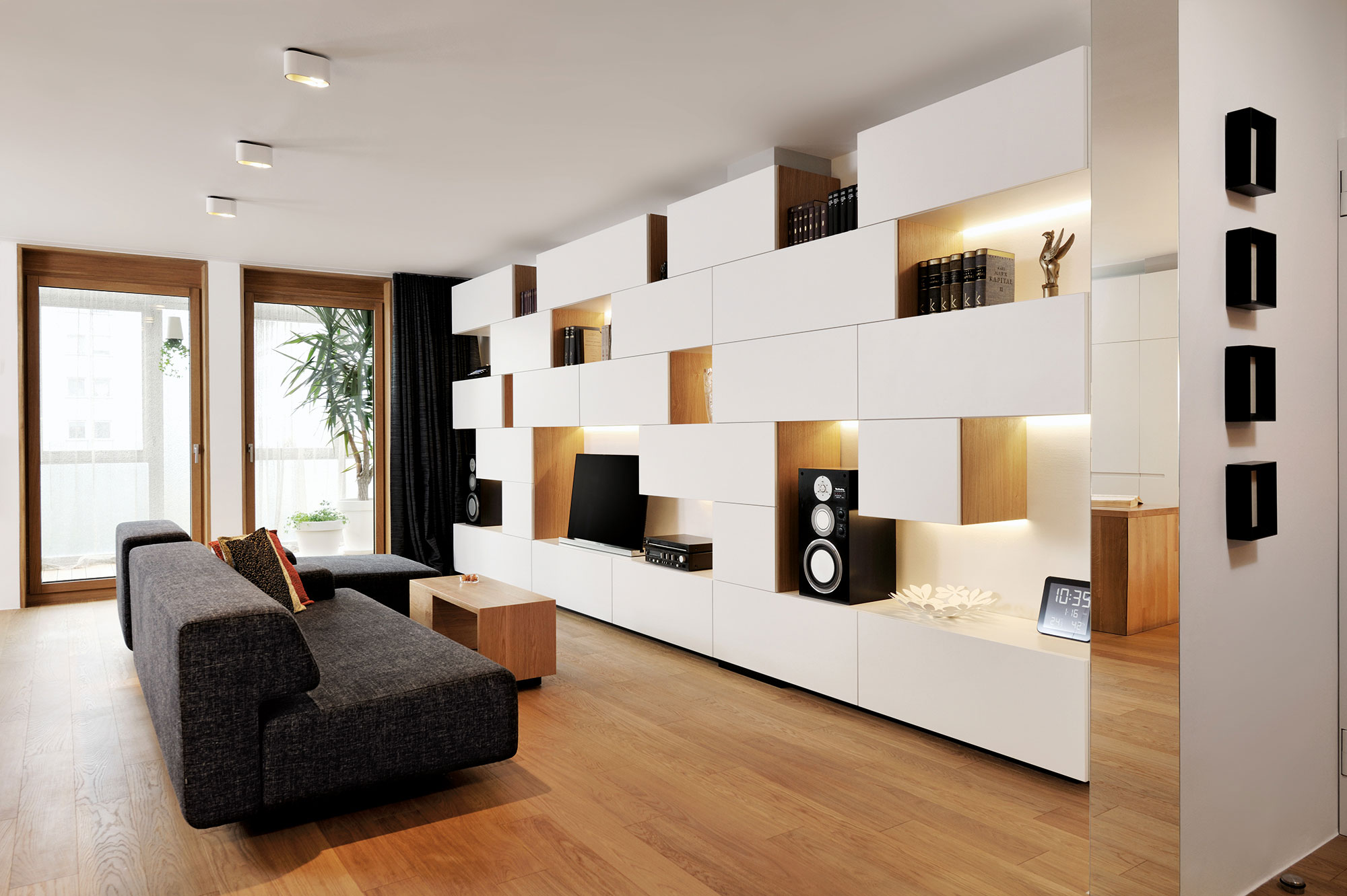 An Elegant L-Shaped Apartment with Walls of Modular Shelving and Storage in Ljubljana by Lidija Dragisic (1)