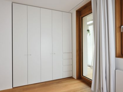 An Elegant L-Shaped Apartment with Walls of Modular Shelving and Storage in Ljubljana by Lidija Dragisic (12)