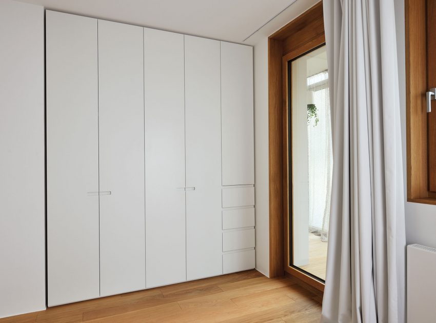 An Elegant L-Shaped Apartment with Walls of Modular Shelving and Storage in Ljubljana by Lidija Dragisic (12)